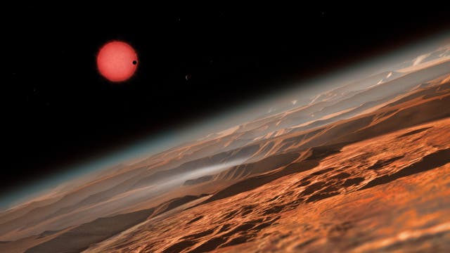 Künstlerische Darstellung des sehr kühlen Zwergsterns TRAPPIST-1 aus der Nähe eines seiner Planeten.