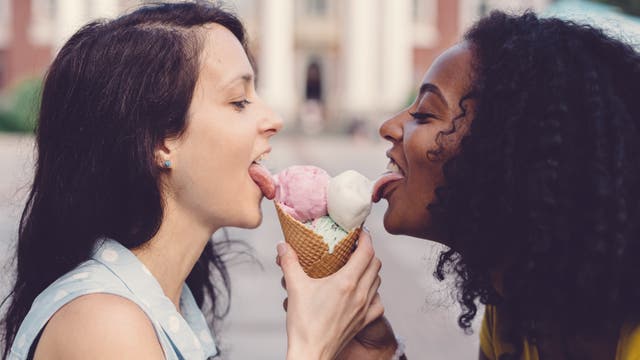 Freundinnen lecken gemeinsam an einem Eis 