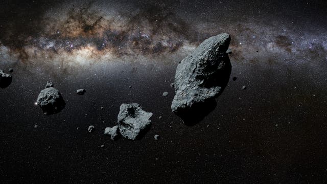 Die Illustration zeigt einen Asteroiden-Schwarm im All.
