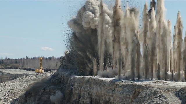 Eine kontrollierte Sprengung in einem Steinbruch erzeugt Staubsäulen.