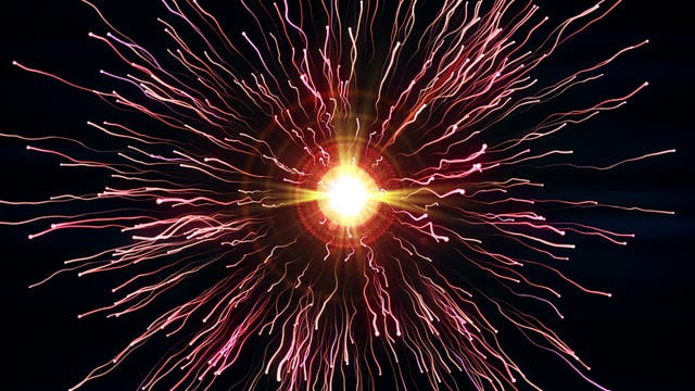 Ein leuchtendes Feuerwerk explodiert in der Dunkelheit des Nachthimmels. Helle, farbige Lichtstrahlen strahlen von einem zentralen Punkt aus und erzeugen ein beeindruckendes Muster aus roten und gelben Linien. Die Szene vermittelt ein Gefühl von Feierlichkeit und Freude.
