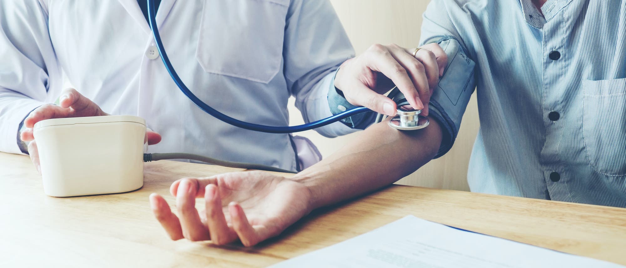 Arzt misst bei Patient den Blutdruck Arzt misst bei Patient den Blutdruck