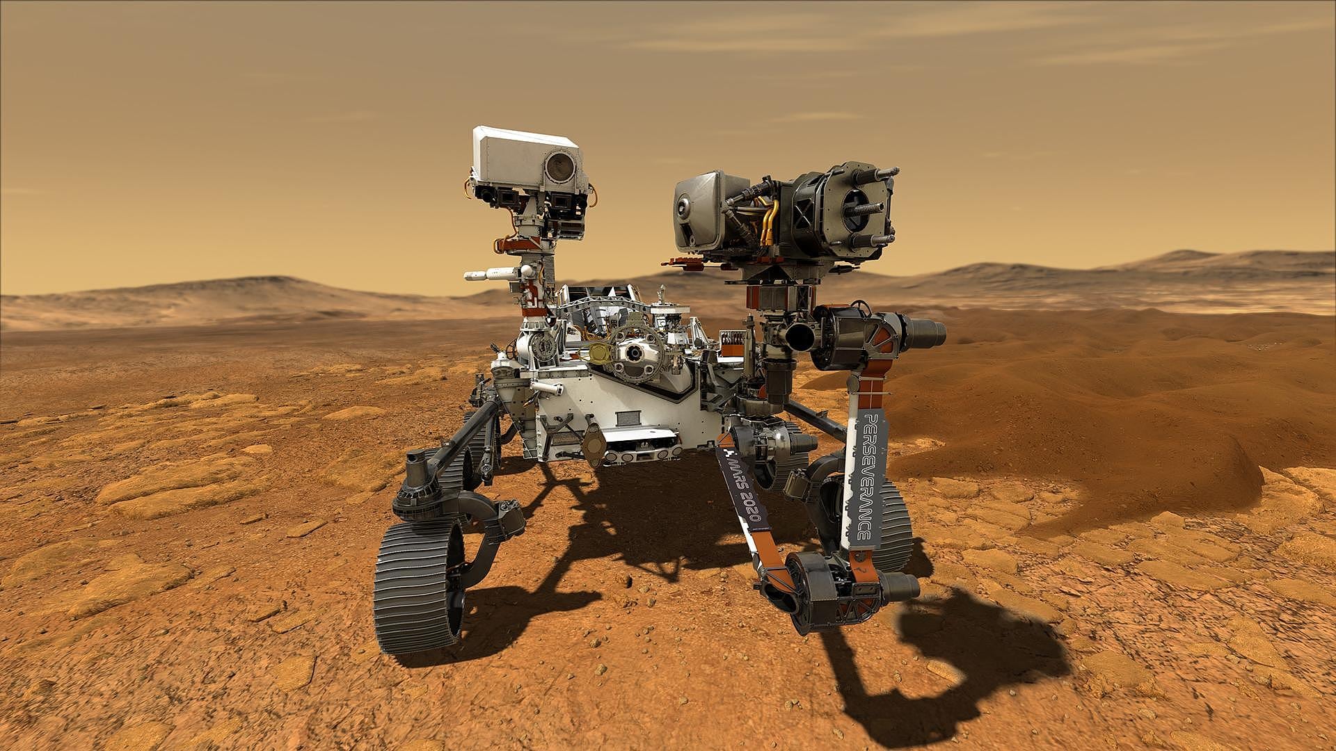 Künstlerische Darstellung des Rovers Perseverance auf dem Mars. Ein Robotergefährt in rötlicher Wüste unter orangefarbenem Himmel. Künstlerische Darstellung des Rovers Perseverance auf dem Mars. Ein Robotergefährt in rötlicher Wüste unter orangefarbenem Himmel.